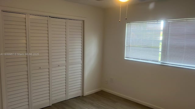 7230 NW 3rd St, Miami, FL 33126 - unfurnished bedroom with wood finished floors and a closet