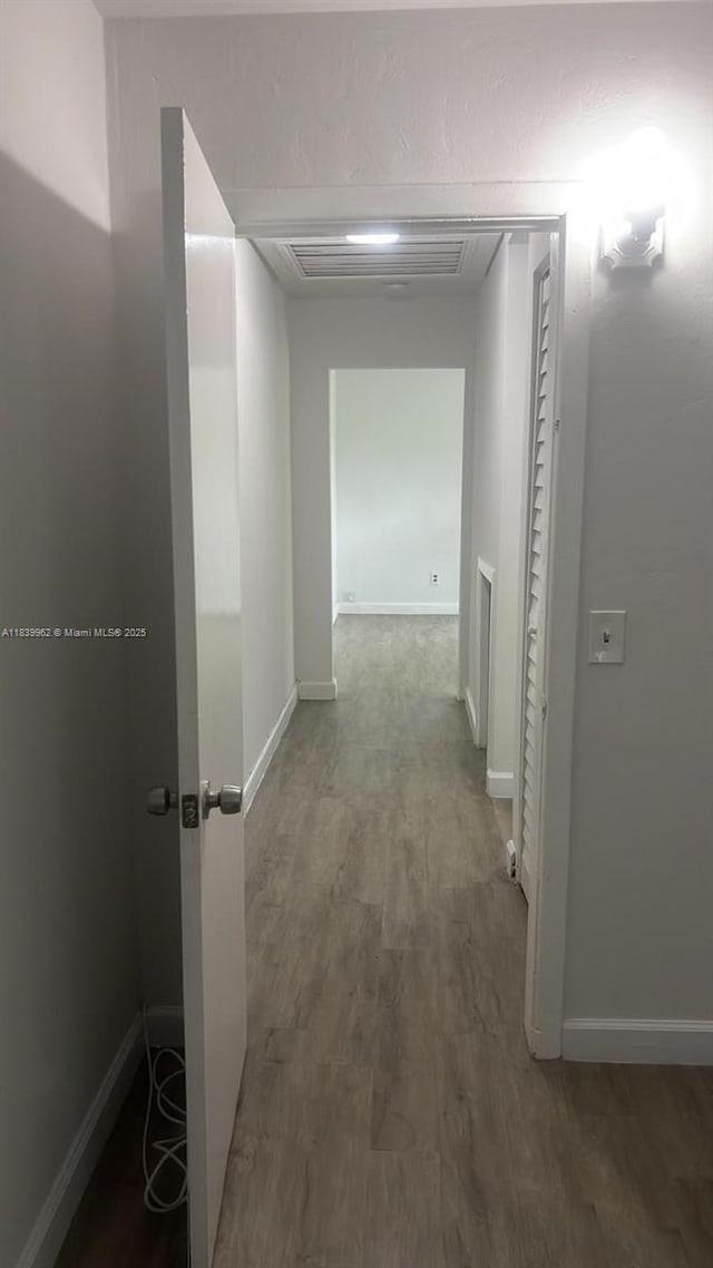 7230 NW 3rd St, Miami, FL 33126 - corridor featuring wood finished floors and baseboards
