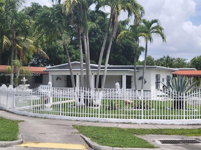 305 NW Opa Locka Blvd, North Miami, FL 33168 - view of front of house featuring covered porch and a fenced front yard