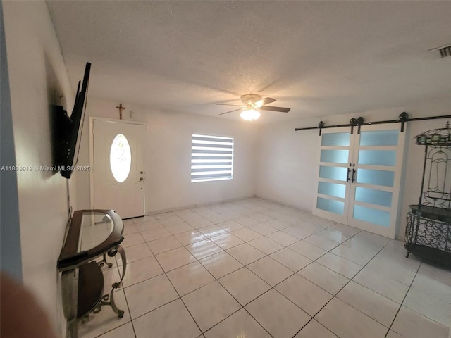 305 NW Opa Locka Blvd, North Miami, FL 33168 - foyer featuring light tile patterned floors, a barn door, and ceiling fan