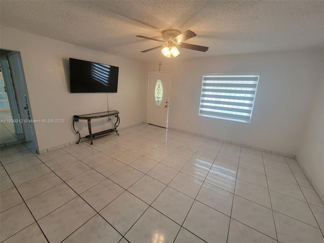 305 NW Opa Locka Blvd, North Miami, FL 33168 - unfurnished living room featuring a ceiling fan, light tile patterned floors, and a textured ceiling