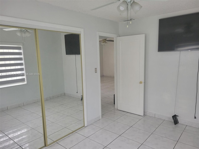 305 NW Opa Locka Blvd, North Miami, FL 33168 - unfurnished bedroom with light tile patterned floors, a closet, a ceiling fan, and a textured ceiling
