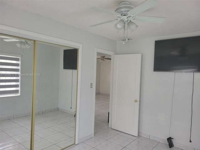305 NW Opa Locka Blvd, North Miami, FL 33168 - unfurnished bedroom with light tile patterned flooring, ceiling fan, a textured ceiling, and a closet