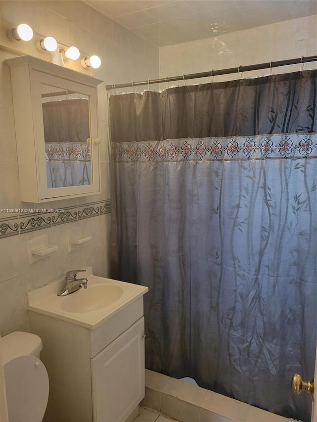305 NW Opa Locka Blvd, North Miami, FL 33168 - full bathroom featuring vanity, tile walls, and a shower with shower curtain