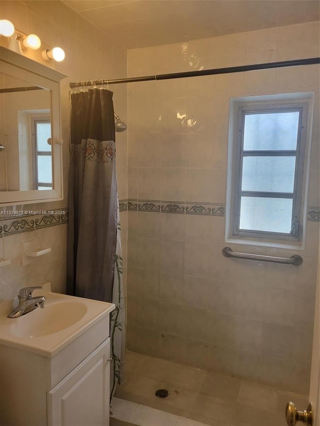 305 NW Opa Locka Blvd, North Miami, FL 33168 - full bathroom with a tile shower, vanity, and tile walls