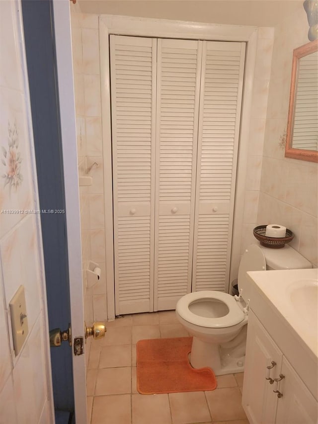 305 NW Opa Locka Blvd, North Miami, FL 33168 - bathroom with a closet, vanity, tile patterned floors, and tile walls