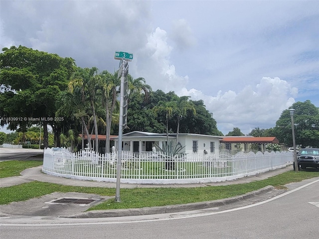 305 NW Opa Locka Blvd, North Miami, FL 33168 - view of front facade with a fenced front yard