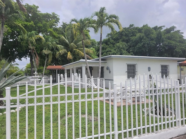 305 NW Opa Locka Blvd, North Miami, FL 33168 - view of front facade with a fenced front yard, stucco siding, and a porch