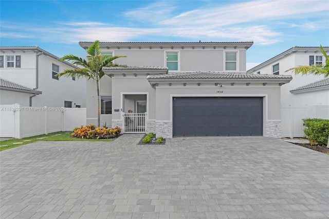 14864 SW 163rd Ter, Miami, FL 33187 - mediterranean / spanish home with stucco siding, a garage, decorative driveway, and stone siding