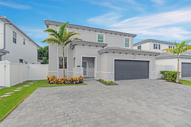 14864 SW 163rd Ter, Miami, FL 33187 - mediterranean / spanish-style home with stucco siding, a gate, stone siding, decorative driveway, and a tiled roof