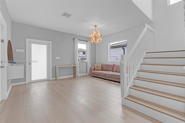 14864 SW 163rd Ter, Miami, FL 33187 - foyer with a chandelier, stairway, and light wood-type flooring