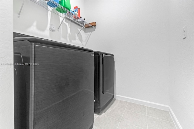 14864 SW 163rd Ter, Miami, FL 33187 - laundry area featuring washing machine and clothes dryer and light tile patterned flooring