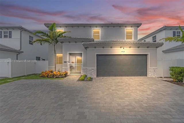 14864 SW 163rd Ter, Miami, FL 33187 - mediterranean / spanish-style home featuring decorative driveway, stucco siding, an attached garage, and stone siding