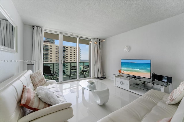 3901 S Ocean Dr Unit 10C, Hollywood, FL 33019 - living room featuring a textured ceiling and tile patterned flooring