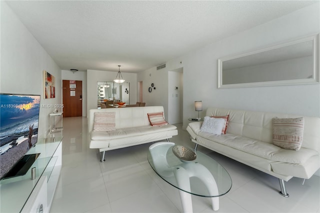 3901 S Ocean Dr Unit 10C, Hollywood, FL 33019 - living area featuring tile patterned flooring and a textured ceiling