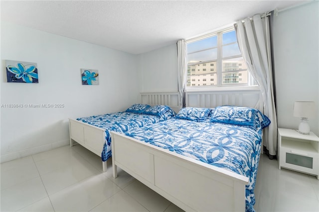 3901 S Ocean Dr Unit 10C, Hollywood, FL 33019 - bedroom featuring a textured ceiling and tile patterned floors