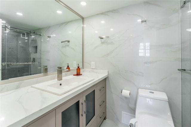 3901 S Ocean Dr Unit 10C, Hollywood, FL 33019 - bathroom with tile walls, vanity, a marble finish shower, and recessed lighting