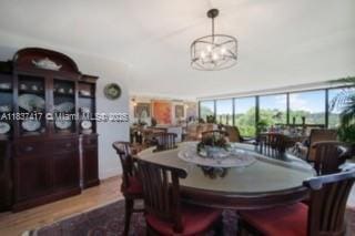 700 Coral Way Unit 4, Coral Gables, FL 33134 - dining room featuring a chandelier and dark wood finished floors