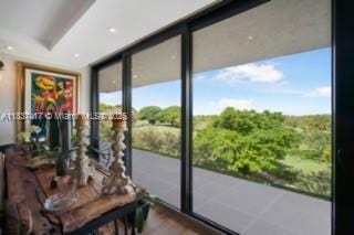 700 Coral Way Unit 4, Coral Gables, FL 33134 - doorway to outside with floor to ceiling windows and wood finished floors