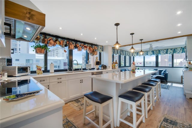 700 Coral Way Unit 4, Coral Gables, FL 33134 - kitchen with healthy amount of natural light, light wood-style flooring, white cabinets, light countertops, and recessed lighting