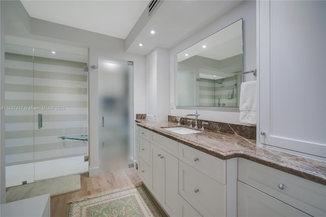 700 Coral Way Unit 4, Coral Gables, FL 33134 - bathroom featuring wood finished floors, vanity, a shower stall, and recessed lighting