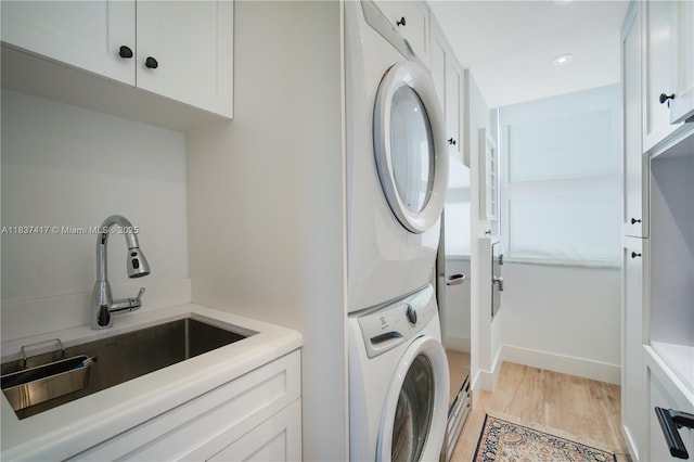 700 Coral Way Unit 4, Coral Gables, FL 33134 - washroom featuring estacked washer and dryer, light wood finished floors, and recessed lighting