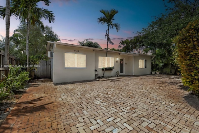 1420 NE 15th Ave, Fort Lauderdale, FL 33304 - back of house at dusk featuring stucco siding