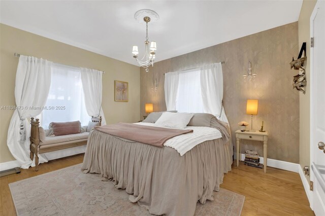 1420 NE 15th Ave, Fort Lauderdale, FL 33304 - bedroom featuring light wood-style flooring and a chandelier