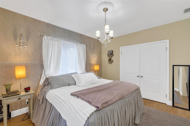 1420 NE 15th Ave, Fort Lauderdale, FL 33304 - bedroom with a chandelier, a closet, and light wood finished floors