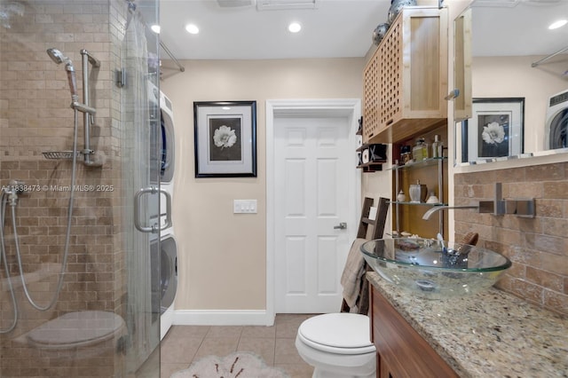 1420 NE 15th Ave, Fort Lauderdale, FL 33304 - full bathroom with stacked washer / dryer, a shower stall, vanity, tile patterned flooring, and recessed lighting
