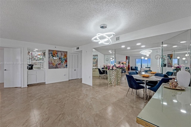 1201 S Ocean Dr Unit 904N, Hollywood, FL 33019 - dining area featuring a chandelier and a textured ceiling