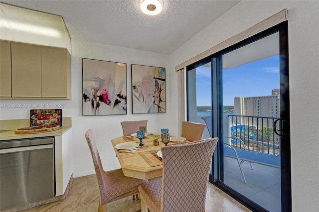 1201 S Ocean Dr Unit 904N, Hollywood, FL 33019 - dining room featuring a textured ceiling and a water view