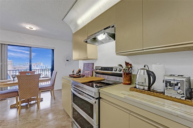 1201 S Ocean Dr Unit 904N, Hollywood, FL 33019 - kitchen featuring range with two ovens, range hood, light countertops, a textured ceiling, and cream cabinets