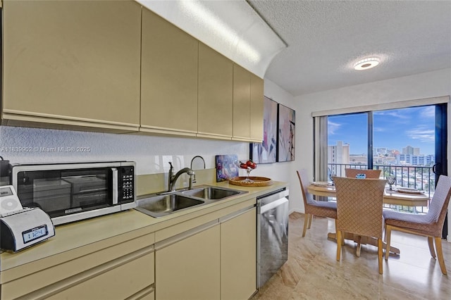 1201 S Ocean Dr Unit 904N, Hollywood, FL 33019 - kitchen featuring stainless steel appliances, light countertops, cream cabinetry, a textured ceiling, and a view of city