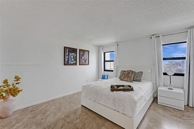 1201 S Ocean Dr Unit 904N, Hollywood, FL 33019 - bedroom featuring a textured ceiling and baseboards