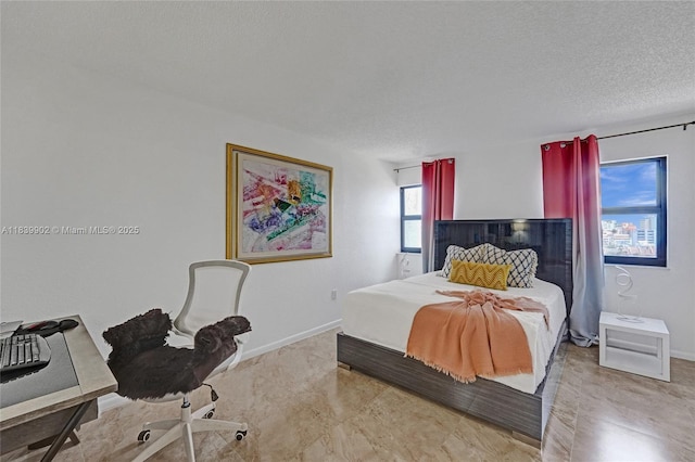 1201 S Ocean Dr Unit 904N, Hollywood, FL 33019 - bedroom featuring a textured ceiling and baseboards