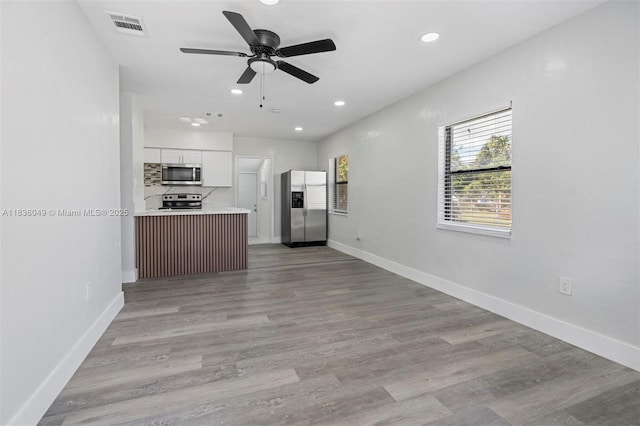 15900 NW 18th Ave, Miami Gardens, FL 33054 - kitchen featuring appliances with stainless steel finishes, white cabinets, open floor plan, light countertops, and a ceiling fan
