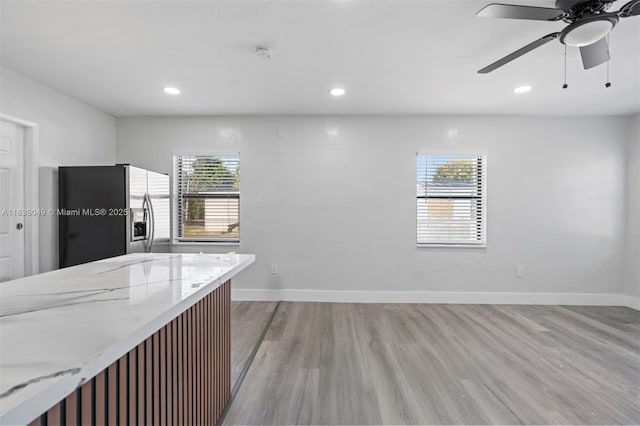 15900 NW 18th Ave, Miami Gardens, FL 33054 - kitchen featuring stainless steel fridge with ice dispenser, light wood-style flooring, a ceiling fan, light stone counters, and recessed lighting
