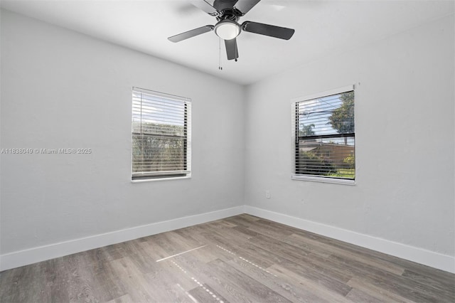 15900 NW 18th Ave, Miami Gardens, FL 33054 - empty room with healthy amount of natural light, wood finished floors, and ceiling fan