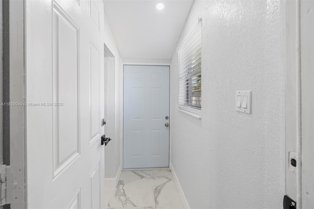 15900 NW 18th Ave, Miami Gardens, FL 33054 - corridor featuring light marble finish flooring, a textured wall, and recessed lighting