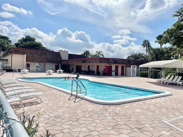1015 Country Club Dr Unit 109, Margate, FL 33063 - community pool featuring a patio area