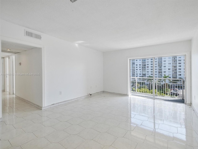 400 Kings Point Dr Unit 523, Sunny Isles Beach, FL 33160 - empty room with a textured ceiling and light tile patterned floors