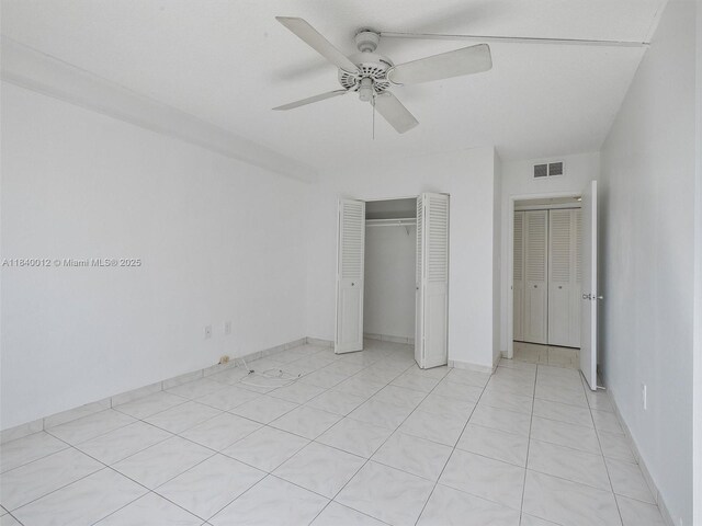 400 Kings Point Dr Unit 523, Sunny Isles Beach, FL 33160 - unfurnished bedroom featuring a closet and ceiling fan