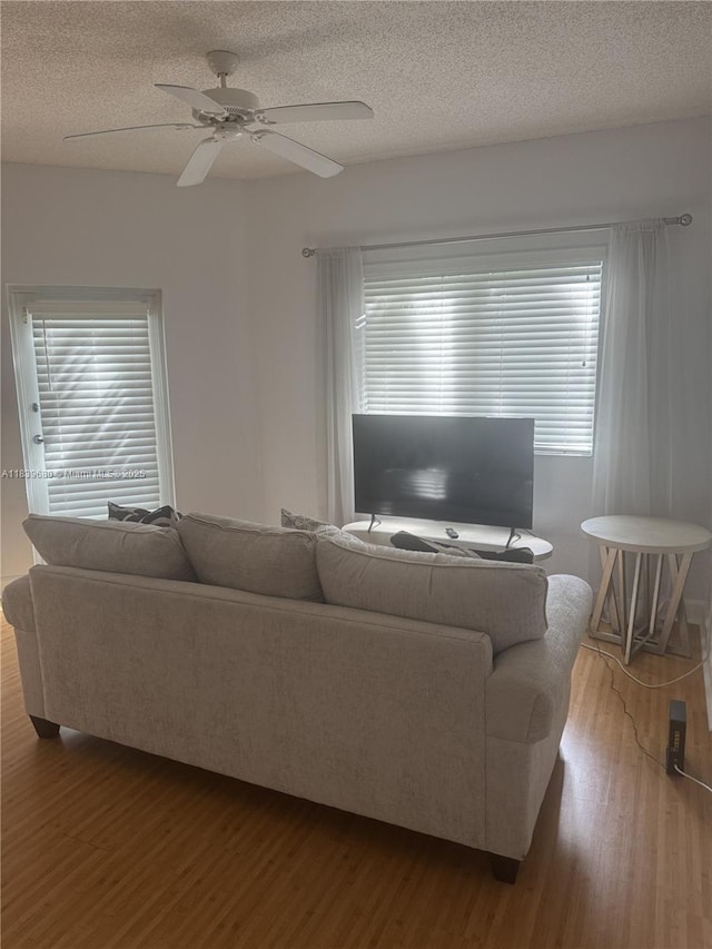 6001 SW 70th St Unit 304, South Miami, FL 33143 - living area with wood finished floors, a textured ceiling, and a ceiling fan