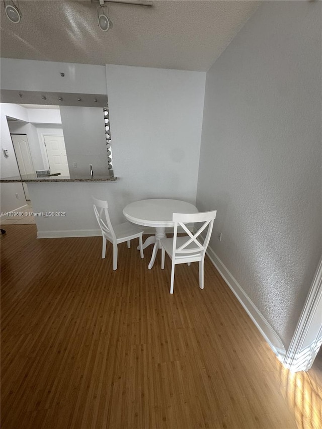 6001 SW 70th St Unit 304, South Miami, FL 33143 - dining space featuring wood finished floors and a textured ceiling