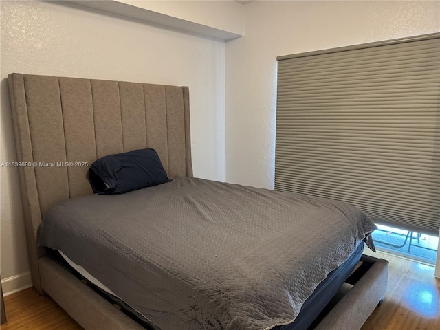6001 SW 70th St Unit 304, South Miami, FL 33143 - bedroom featuring wood finished floors and baseboards