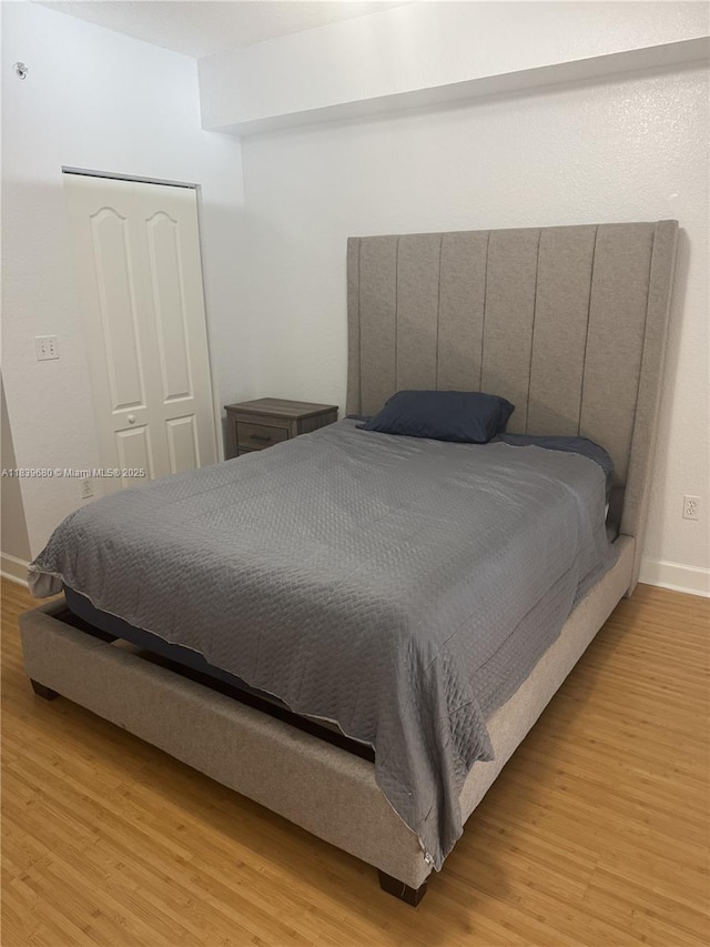 6001 SW 70th St Unit 304, South Miami, FL 33143 - bedroom featuring light wood-type flooring and a closet