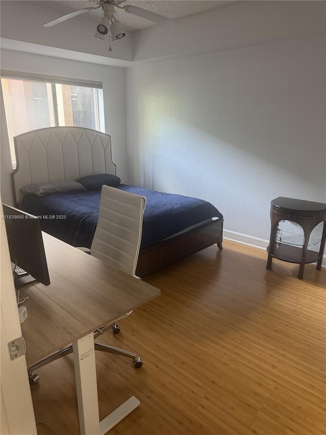 6001 SW 70th St Unit 304, South Miami, FL 33143 - bedroom featuring wood finished floors, ceiling fan, and a textured wall