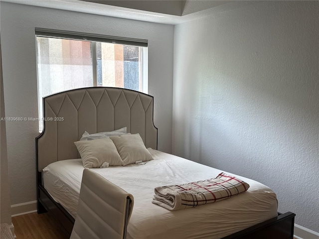 6001 SW 70th St Unit 304, South Miami, FL 33143 - bedroom featuring multiple windows, wood finished floors, and a textured wall