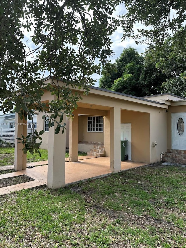 658 SE 8th Pl, Hialeah, FL 33010 - back of house with stucco siding and a patio area